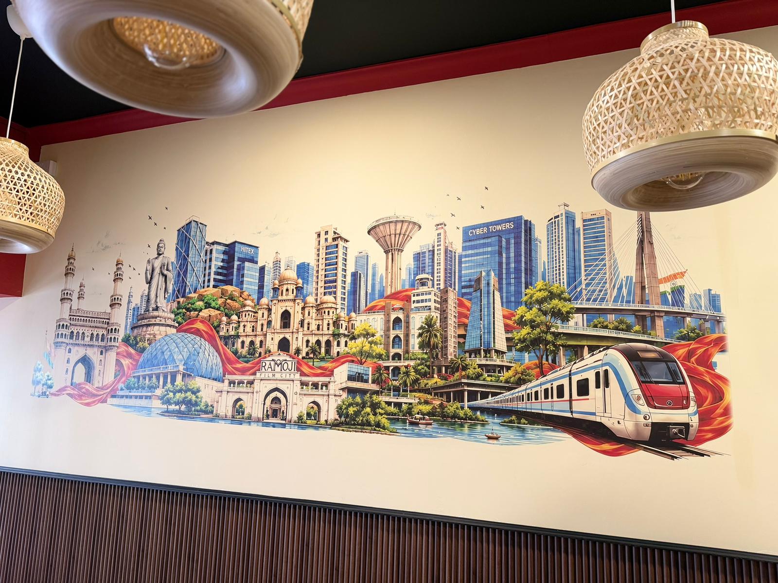 Hyderabad cityscape mural printed across a restaurant wall
