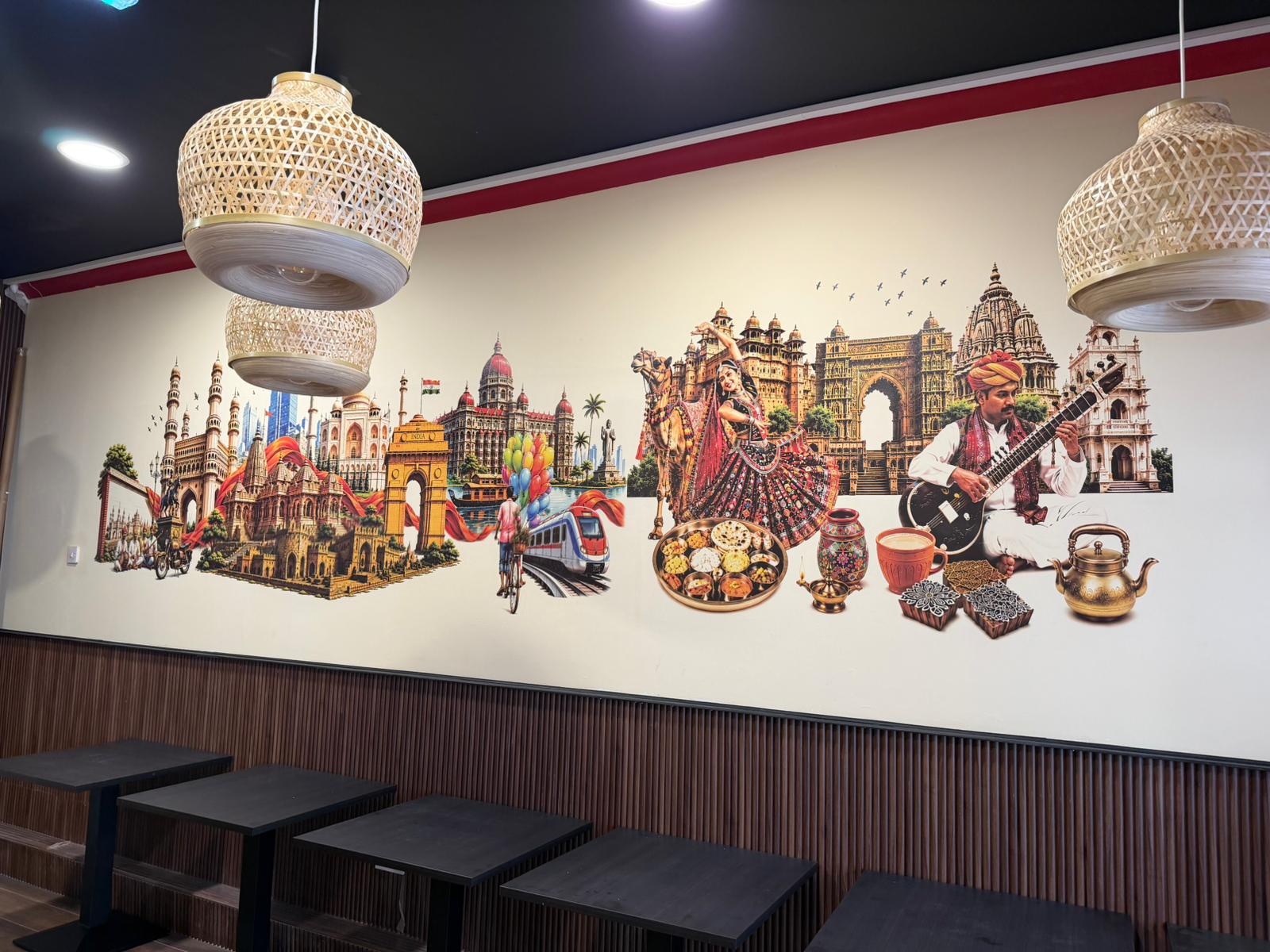 Mural celebrating Indian culture across a restaurant wall